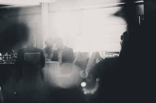 Silhouette of Bride and Groom sitting at wedding