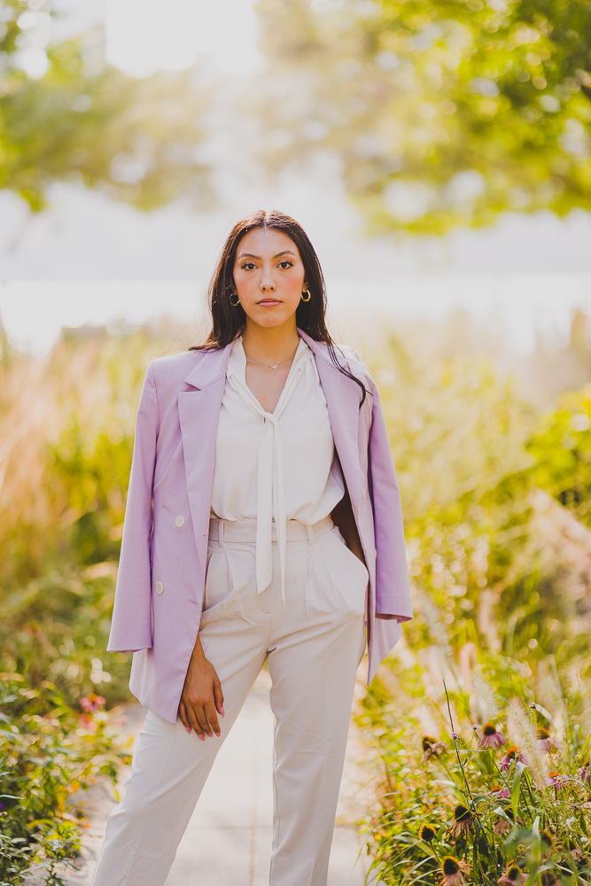 Female Lawyer doing a power pose in front of a tree landscape