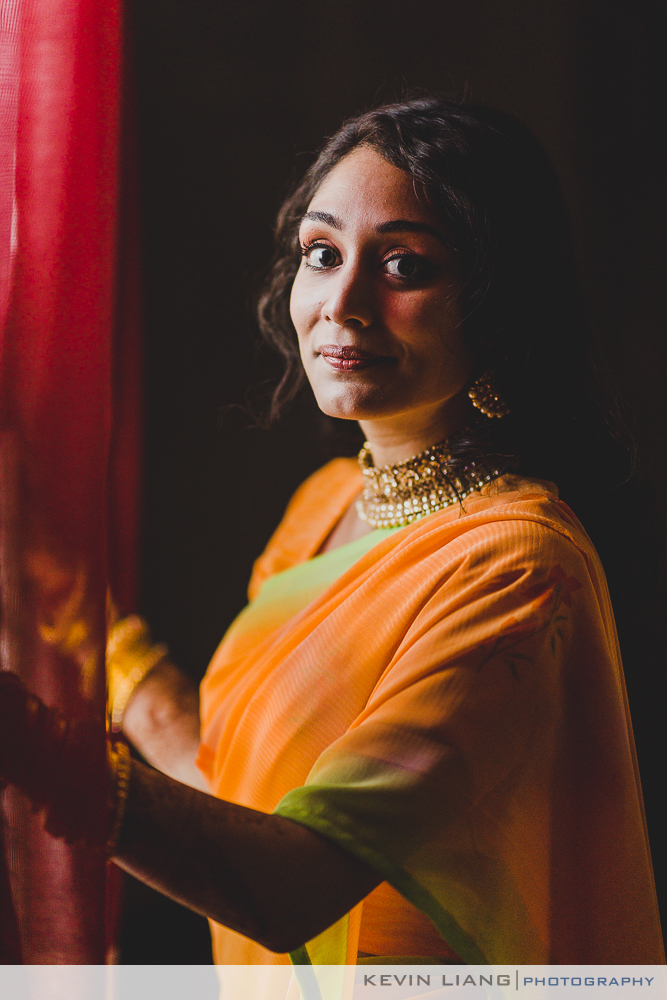 Hindu girl waiting in the window posing for a portrait for a wedding
