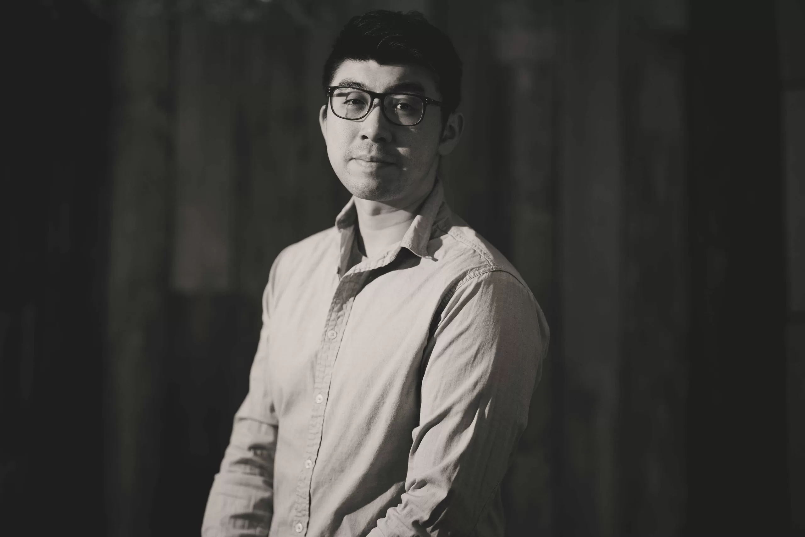 self portrait of a chinese man in a button down shirt in black and white