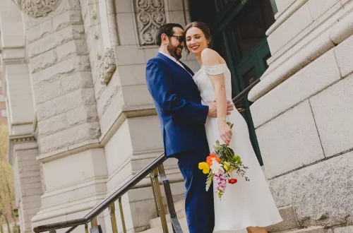Couple in front of civic building after city hall wedding